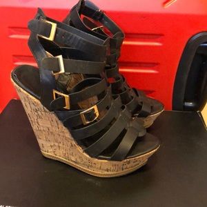 Strappy black wedge sandals with golden buckles